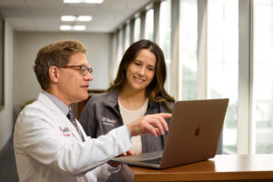 Steven J. Lawrence, MD, a professor of medicine in the Division of Infectious Diseases, discusses Artificial Intelligence (AI) and medical education with medical student Quinn Payton at Bernard Becker Medical Library on October 2, 2025.