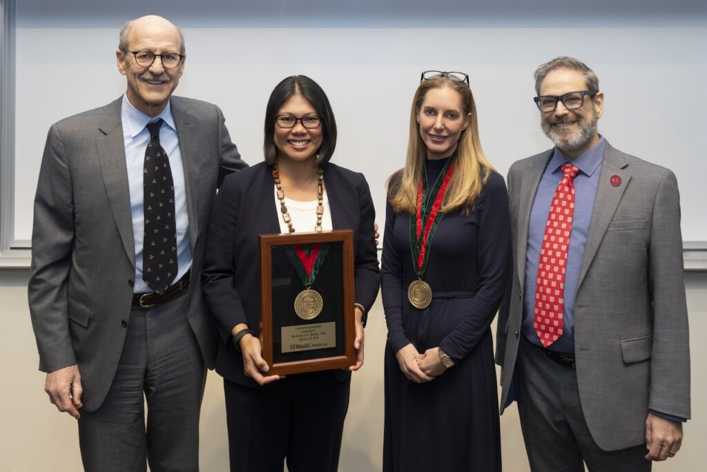 leadership pose for photo to celebrate a clinician receiving award