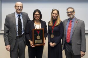 leadership pose for photo to celebrate a clinician receiving award