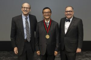 a photo of three leaders at an award ceremony
