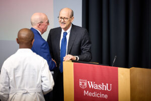 Timothy Eberlein, MD, Director, Alvin J. Siteman Cancer Center, Spencer T. and Ann W. Olin Distinguished Professor, Washington University School of Medicine, greets WashU Medicine Dean David Perlmutter, MD, after his annual State of the School address at EPNEC on April 10, 2026. Perlmutter, executive vice chancellor for medical affairs and the George and Carol Bauer Dean, will conclude his deanship on June 30, 2026.