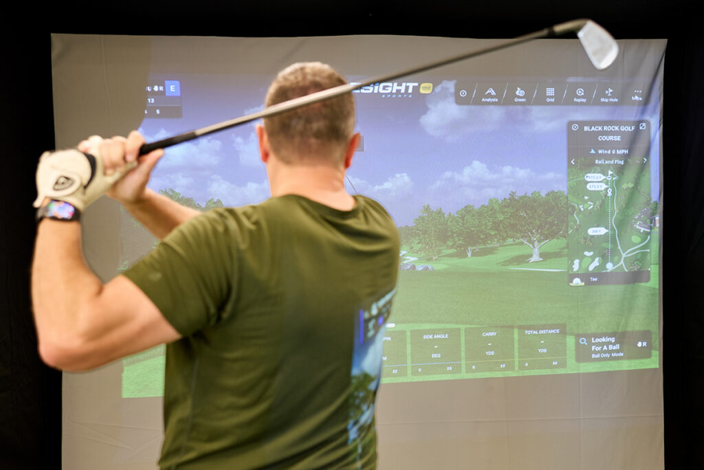 Man swings golf club