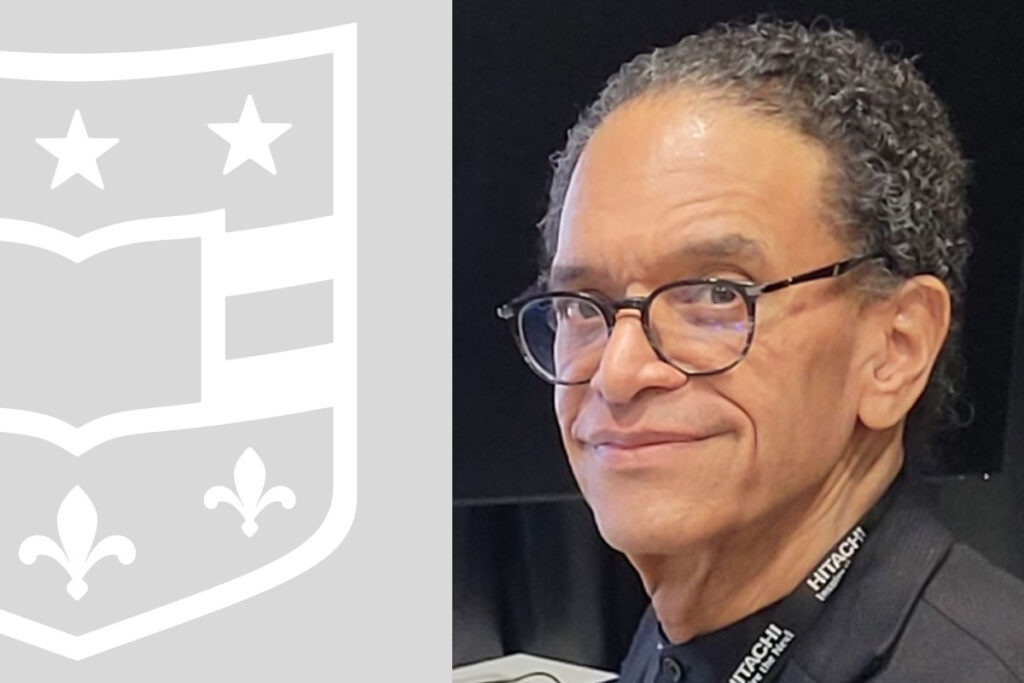 Man in glasses and WashU shield.