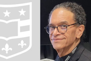 Man in glasses and WashU shield.