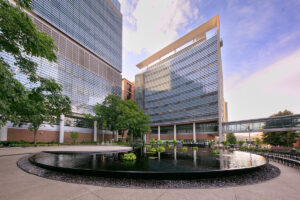 A water feature nearly 80 feet in diameter with a raised platform hovering above an infinity pool.
