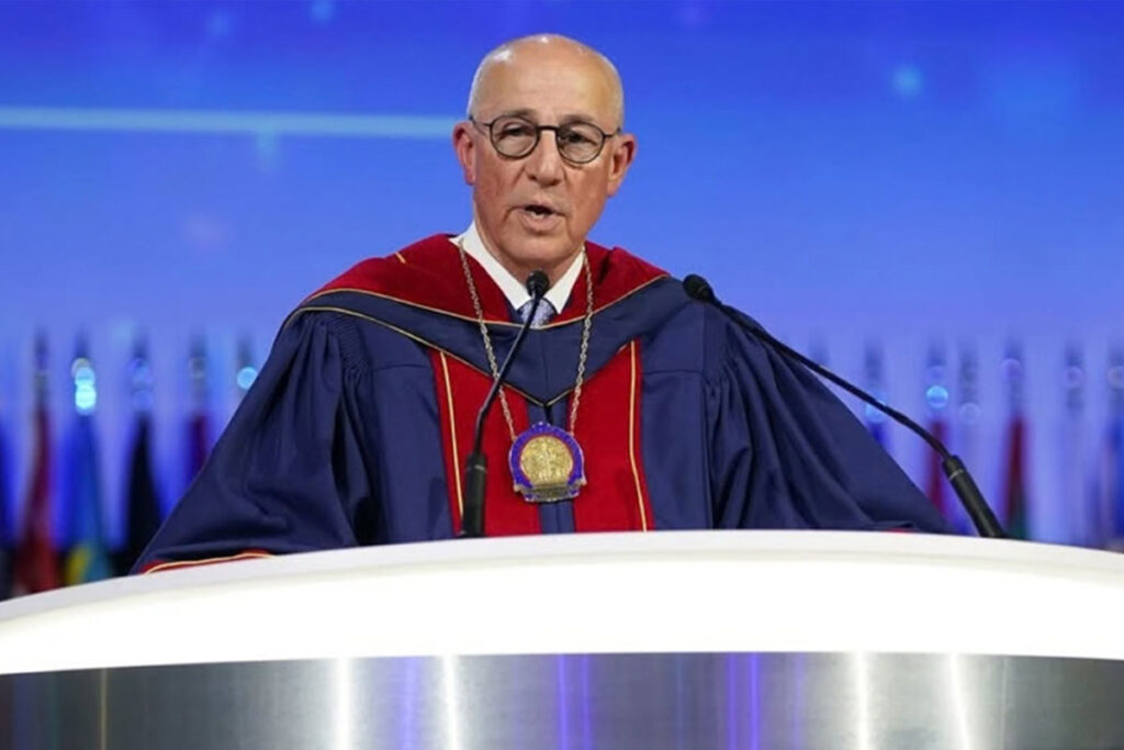 Man at lectern in academic robe